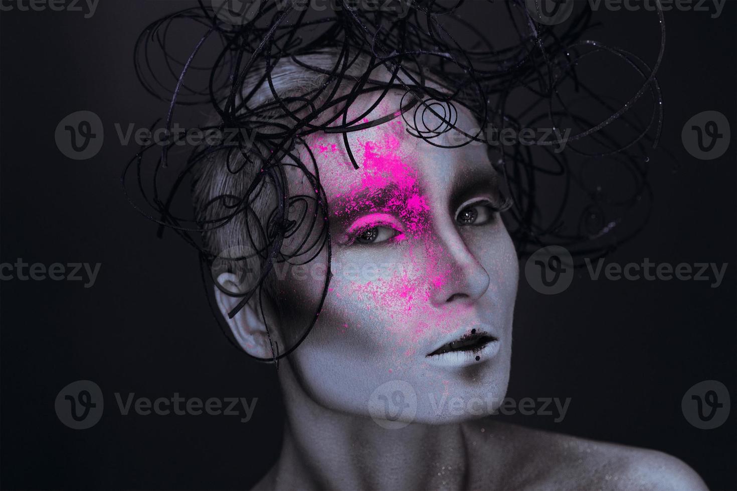 Sexy adult female with neon powred on face photo