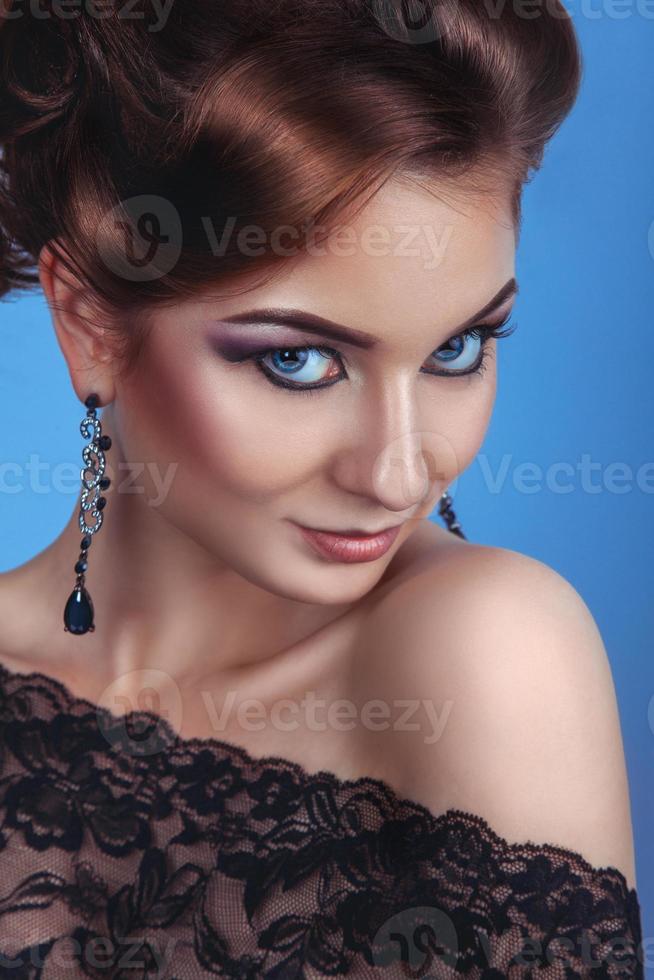 Luxury fashion woman with accessories and make up on blue background photo