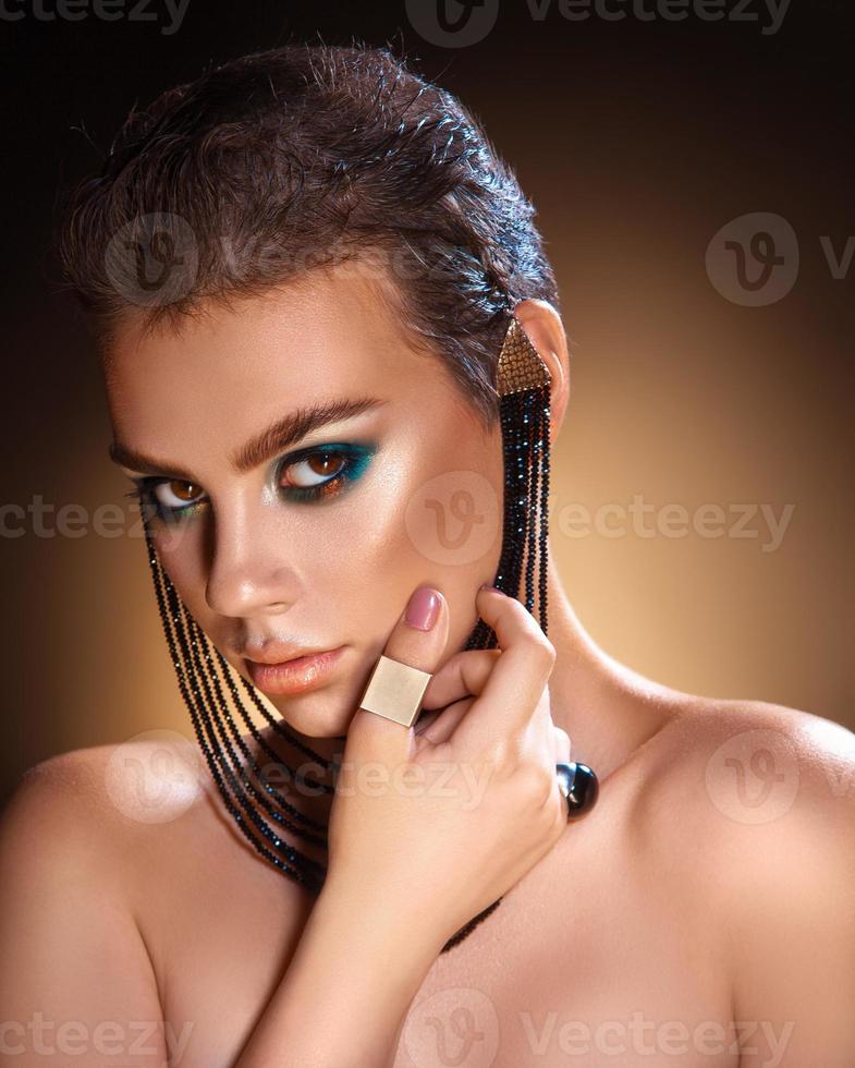 Studio portrait of beautiful girl with healthy skin looking at camera photo