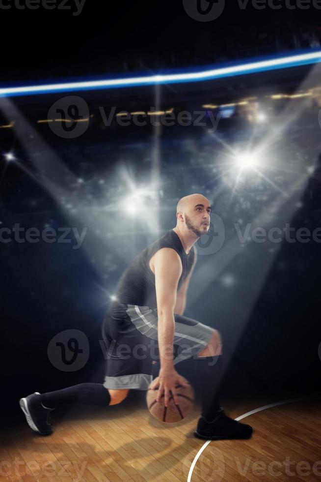 Vertical photo of bald professional basketball player in the game dribbles