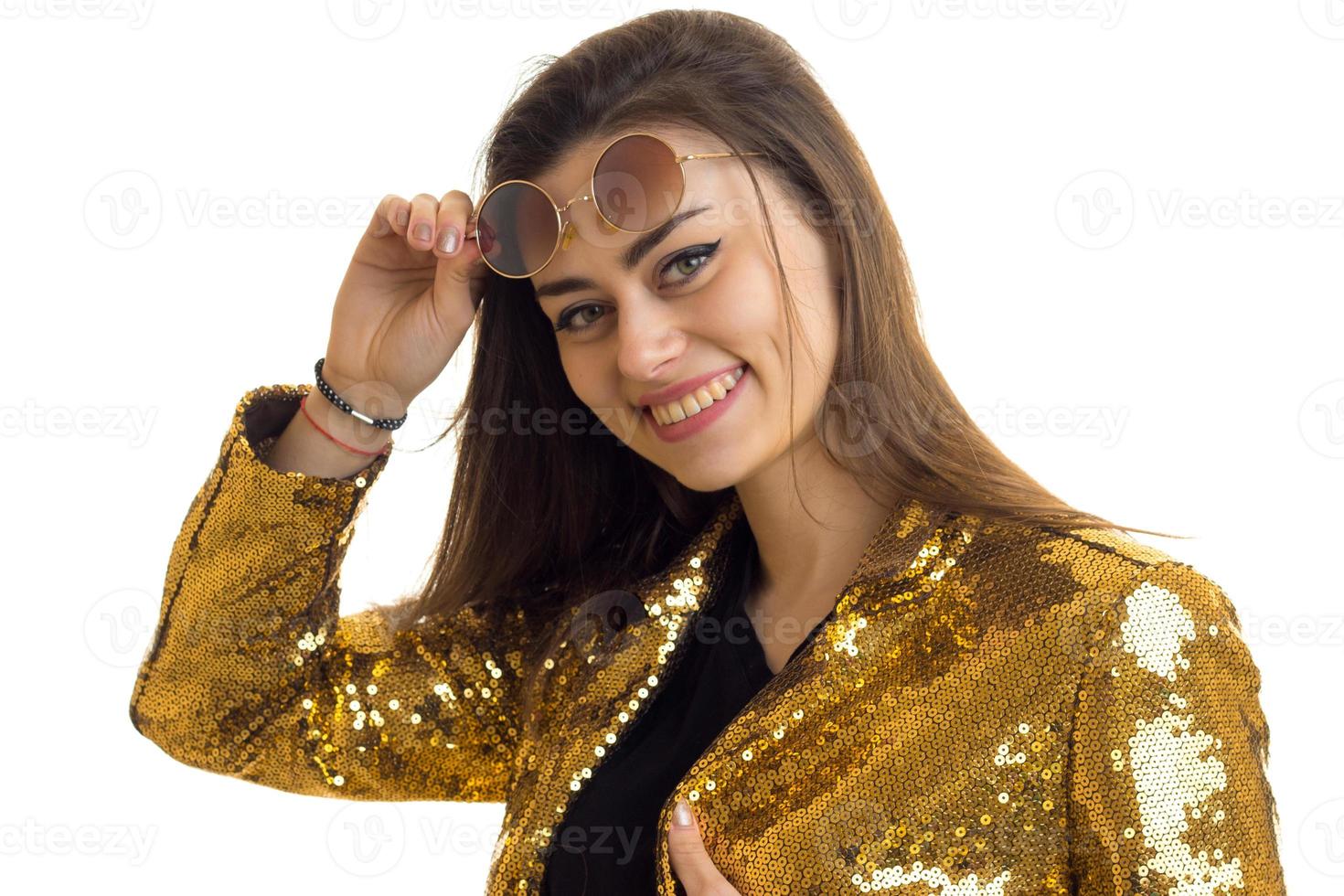horizontal portrait of beautiful fashion girl with glasses in the Golden brilliant jacket photo