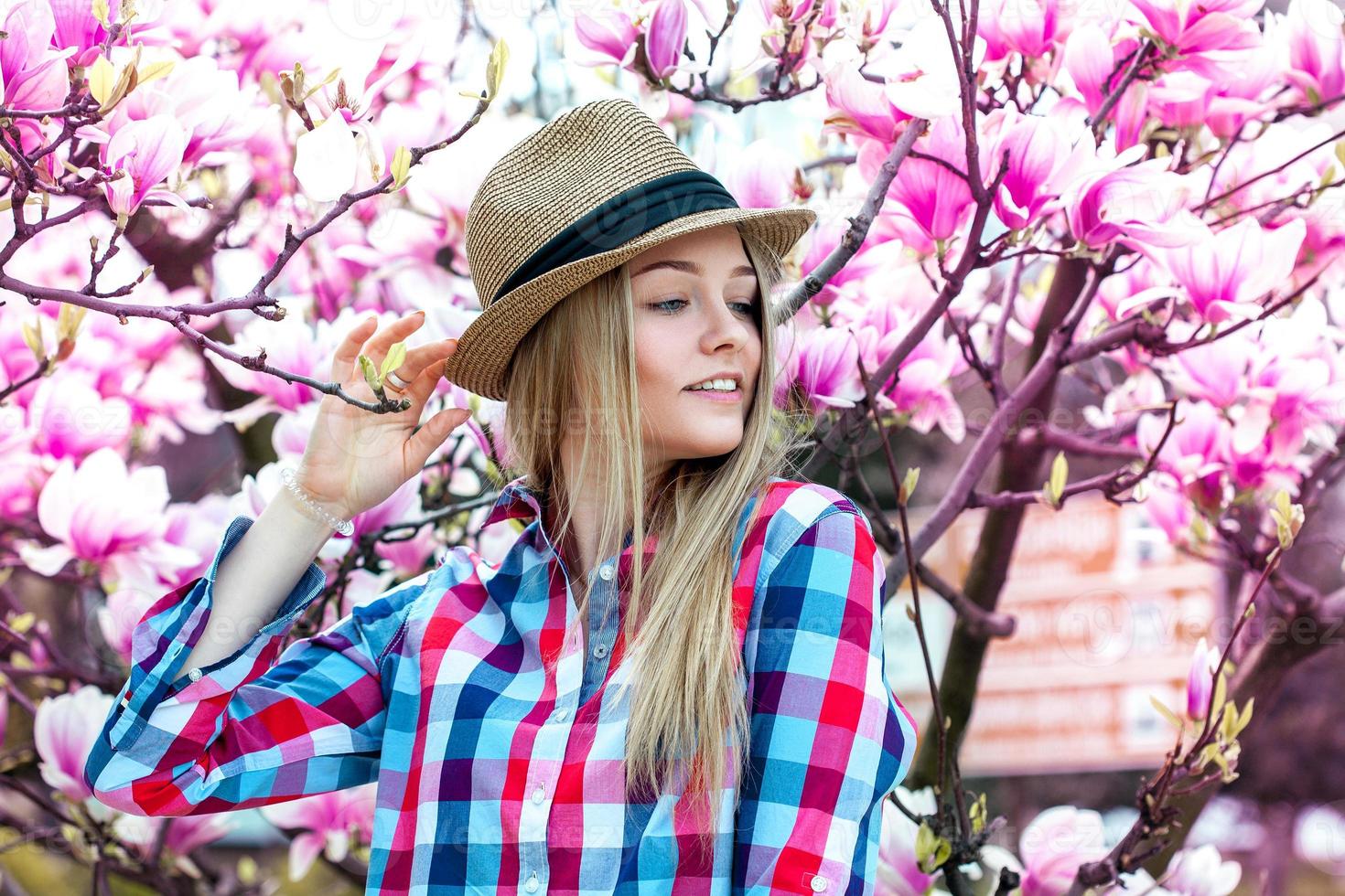 Blonde girl enjoy life with flowers from behind photo