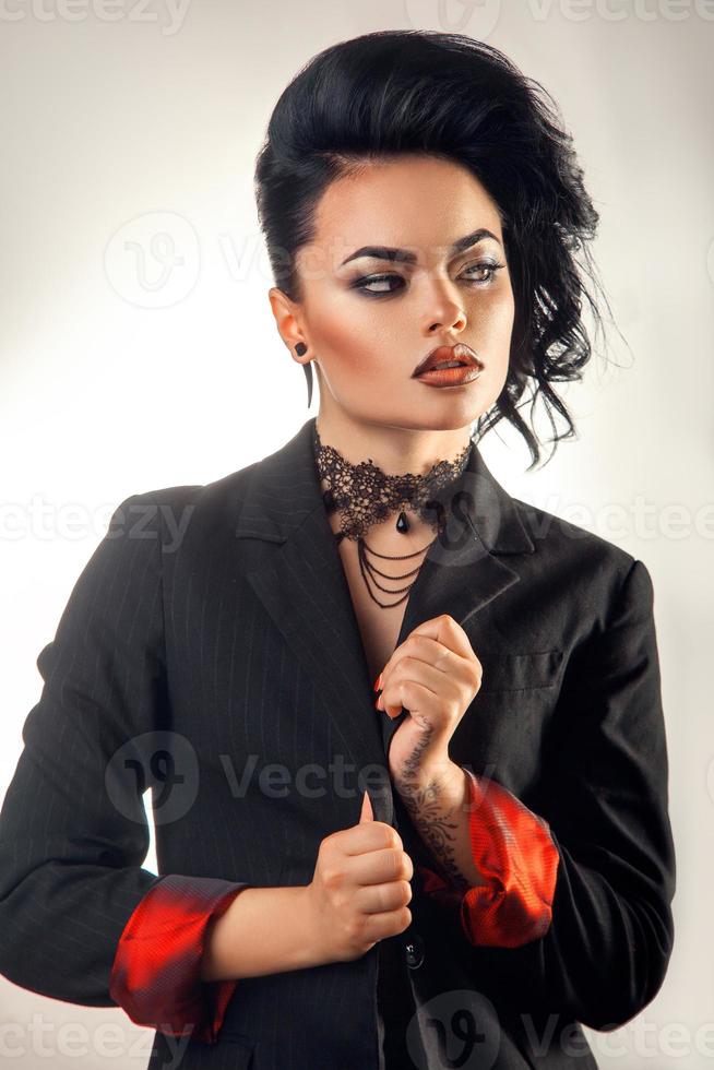 Vertical portrait of nice brunette in jacket with make up photo