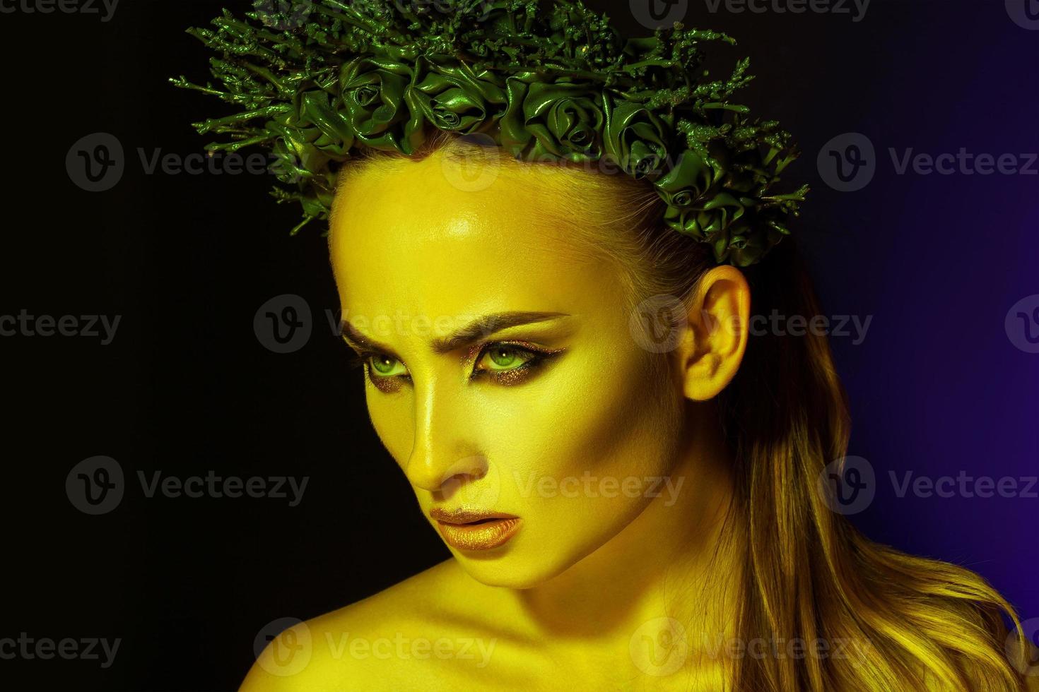 Beauty serious sexy woman with makeup and wreath on head photo