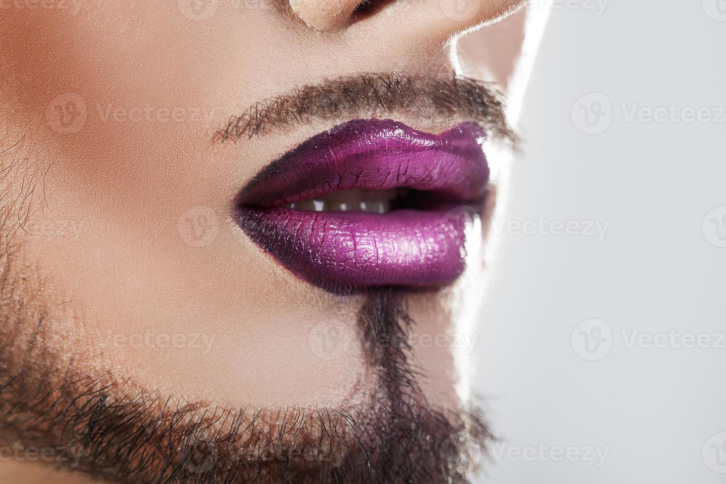 Closeup photo of bearded male lips with makeup