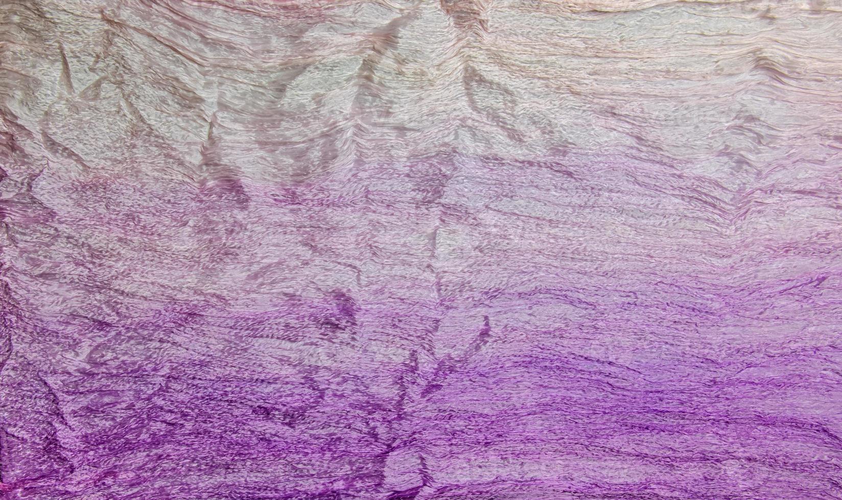 Composition of light cotton fabrics in lilac-pink colors. Background from fabrics. Textile texture. photo