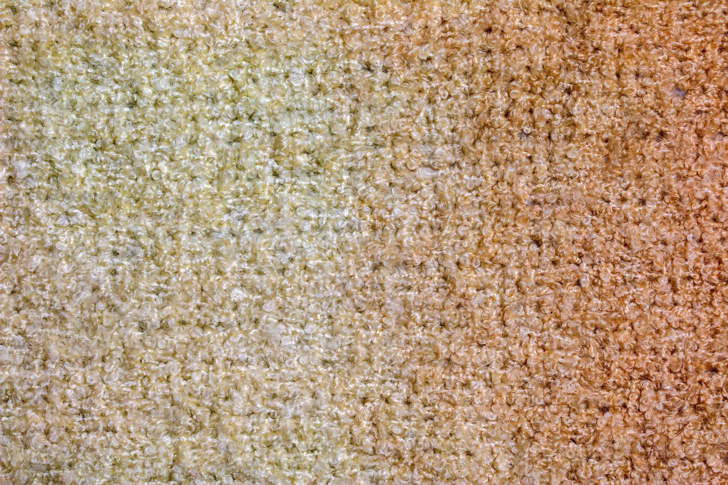 Knitted wool textile textured background in light beige creamy brown shade. Beige color gradient on texture background. photo