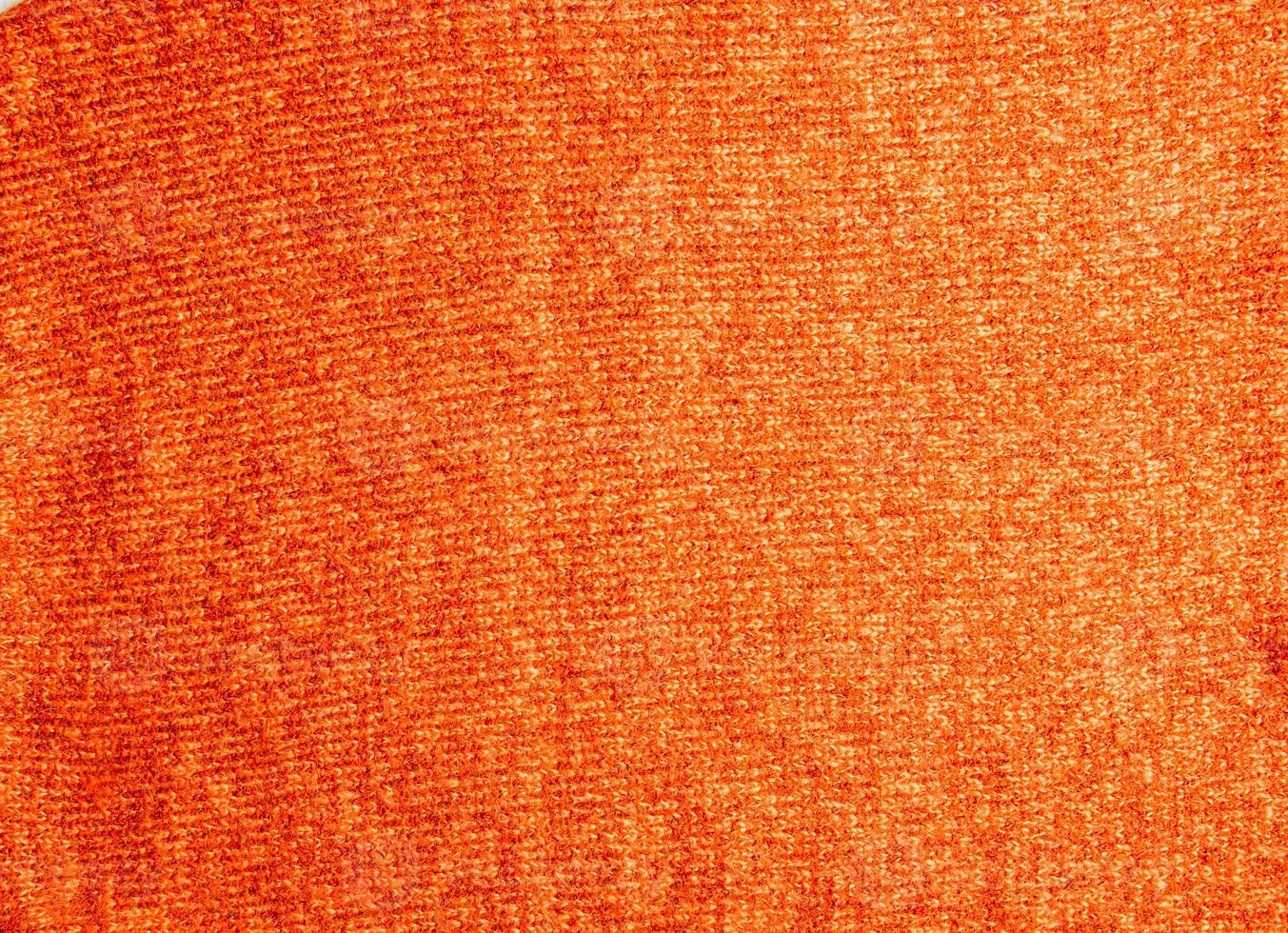 fondo de textura de tejido de punto. tejido de punto. colorido patrón de punto rojo-naranja. hilo rojo foto