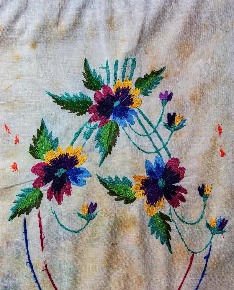 Towel with Ukrainian ethnic ornament, well embroidered with satin stitch, close-up photo