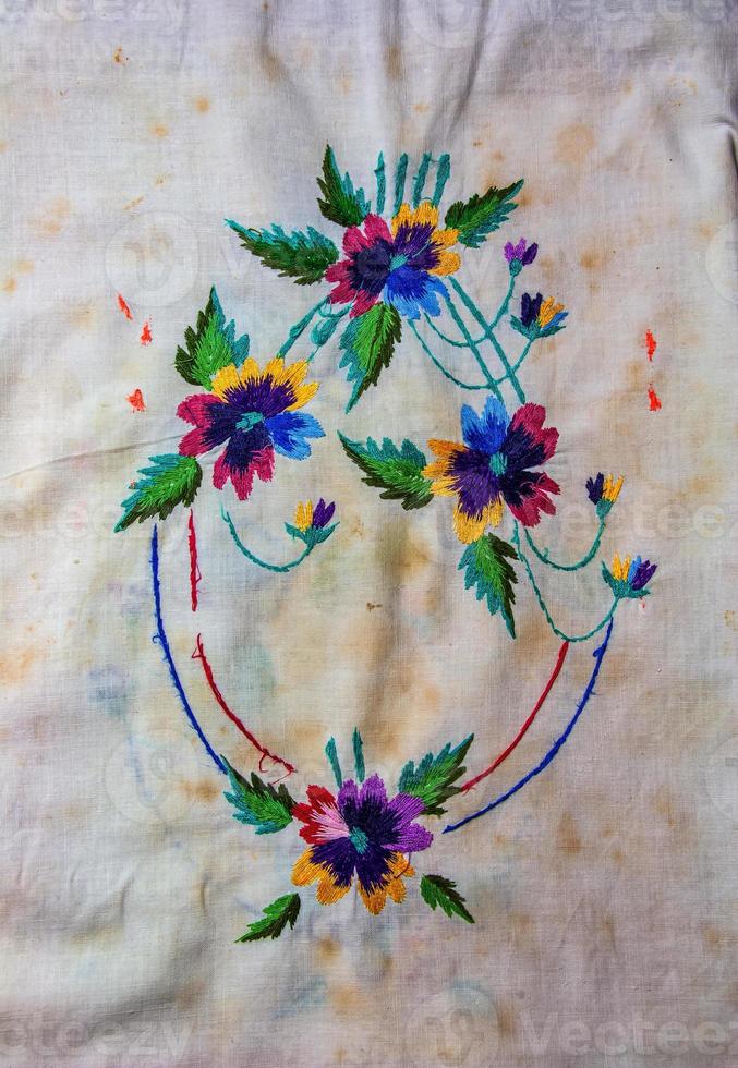 Towel with Ukrainian ethnic ornament, well embroidered with satin stitch, close-up photo