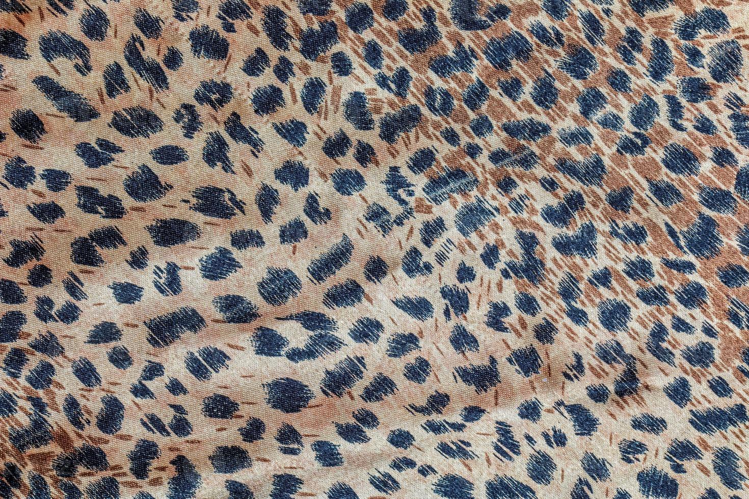 Background with leopard texture, close up. Leopard dyed fabric. photo