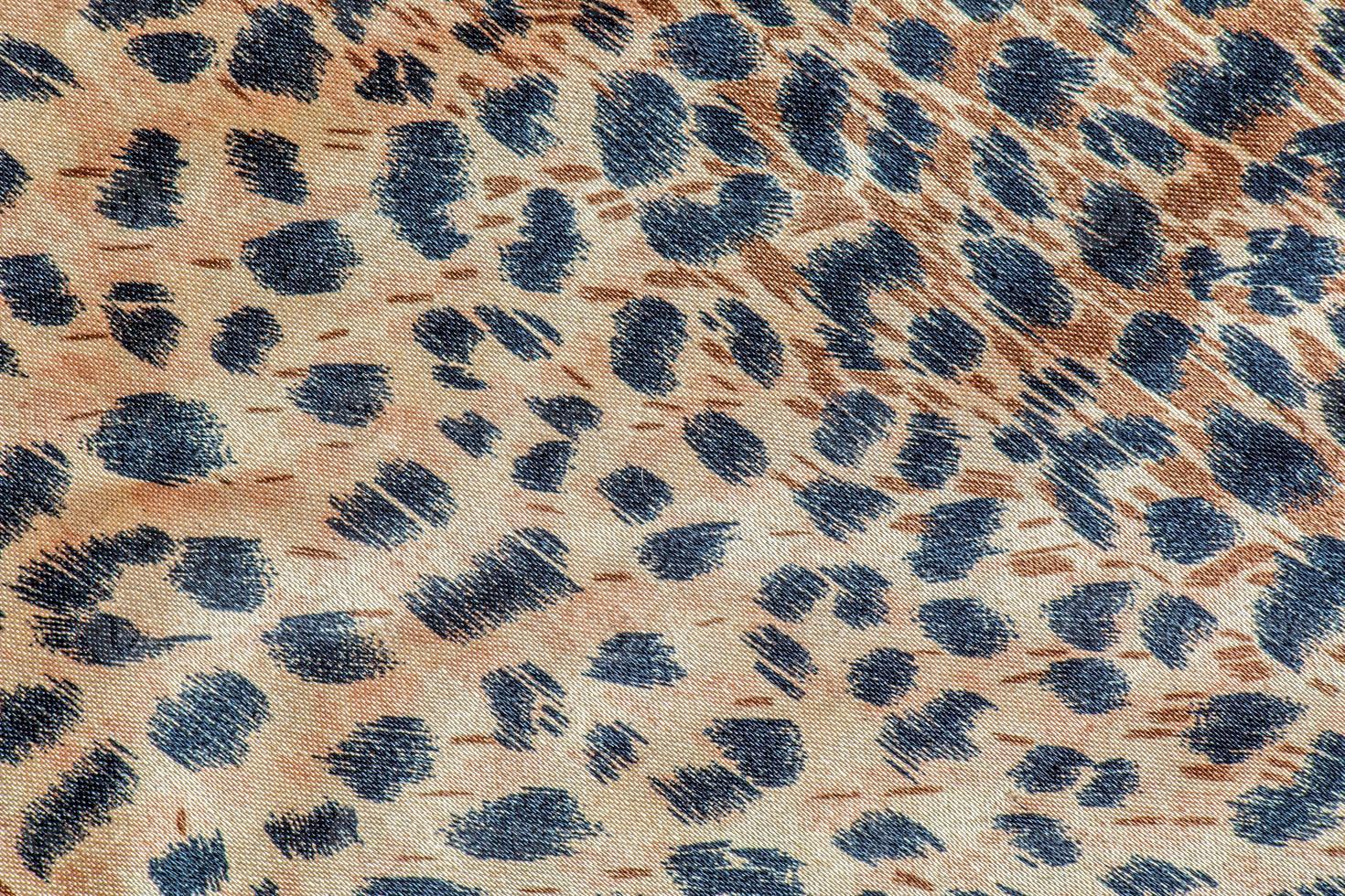 Background with leopard texture, close up. Leopard dyed fabric. photo