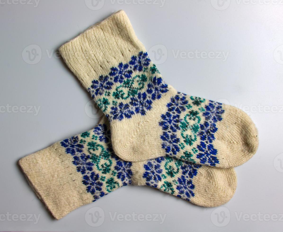 White wool socks with blue-green handmade Argentine merino wool on a white background. photo
