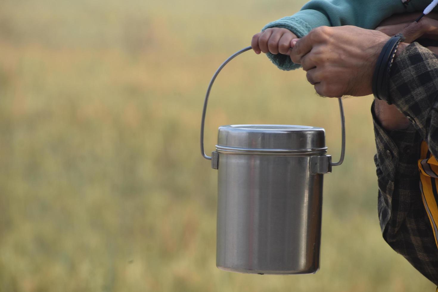 steel tiffin in hand blurr background photo