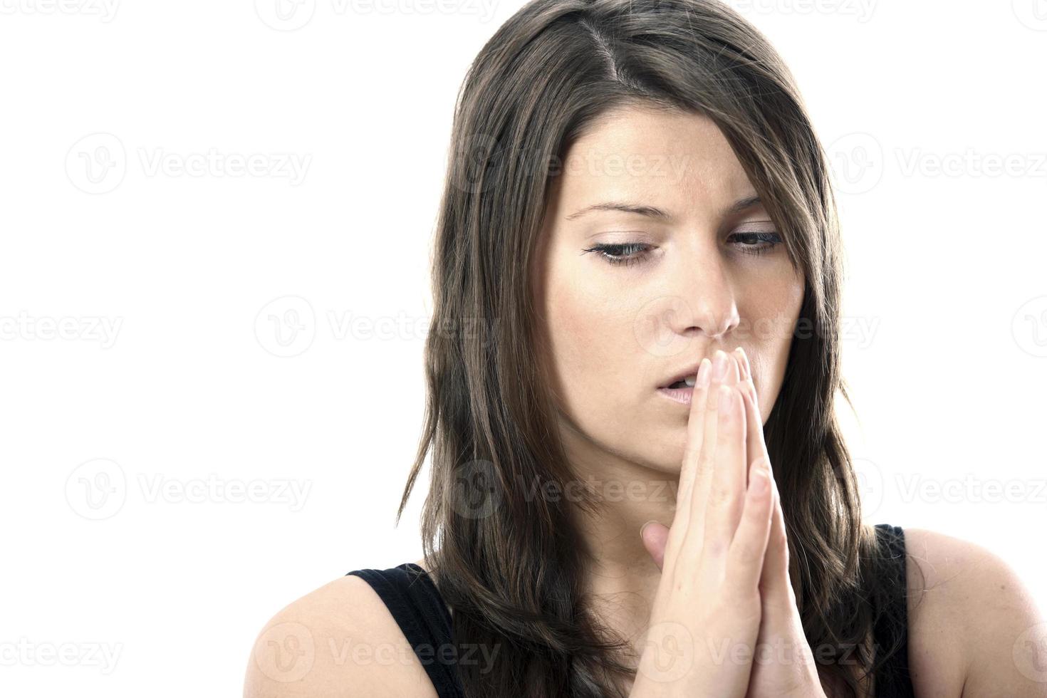 Frightened woman with praying hands photo