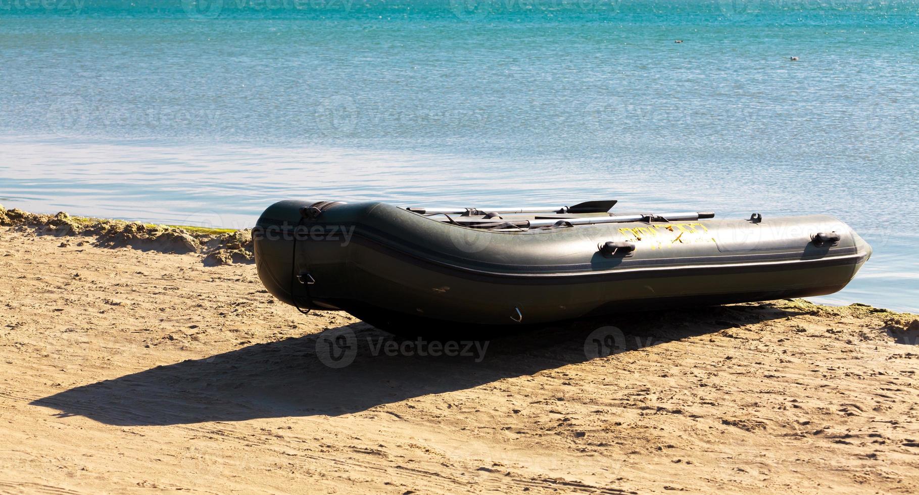 Inflatable boat on seacoast photo