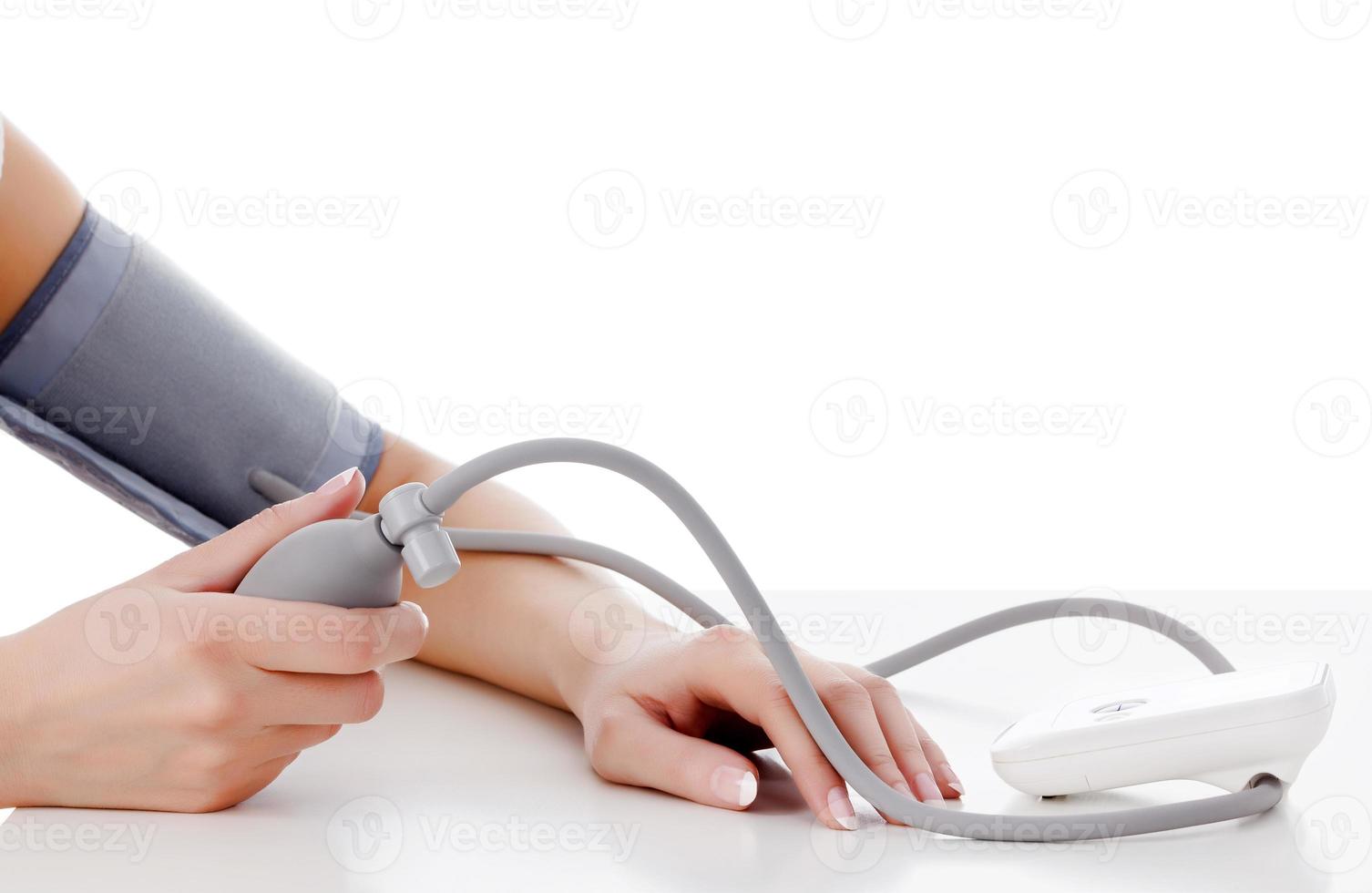 Female measures her blood pressure photo