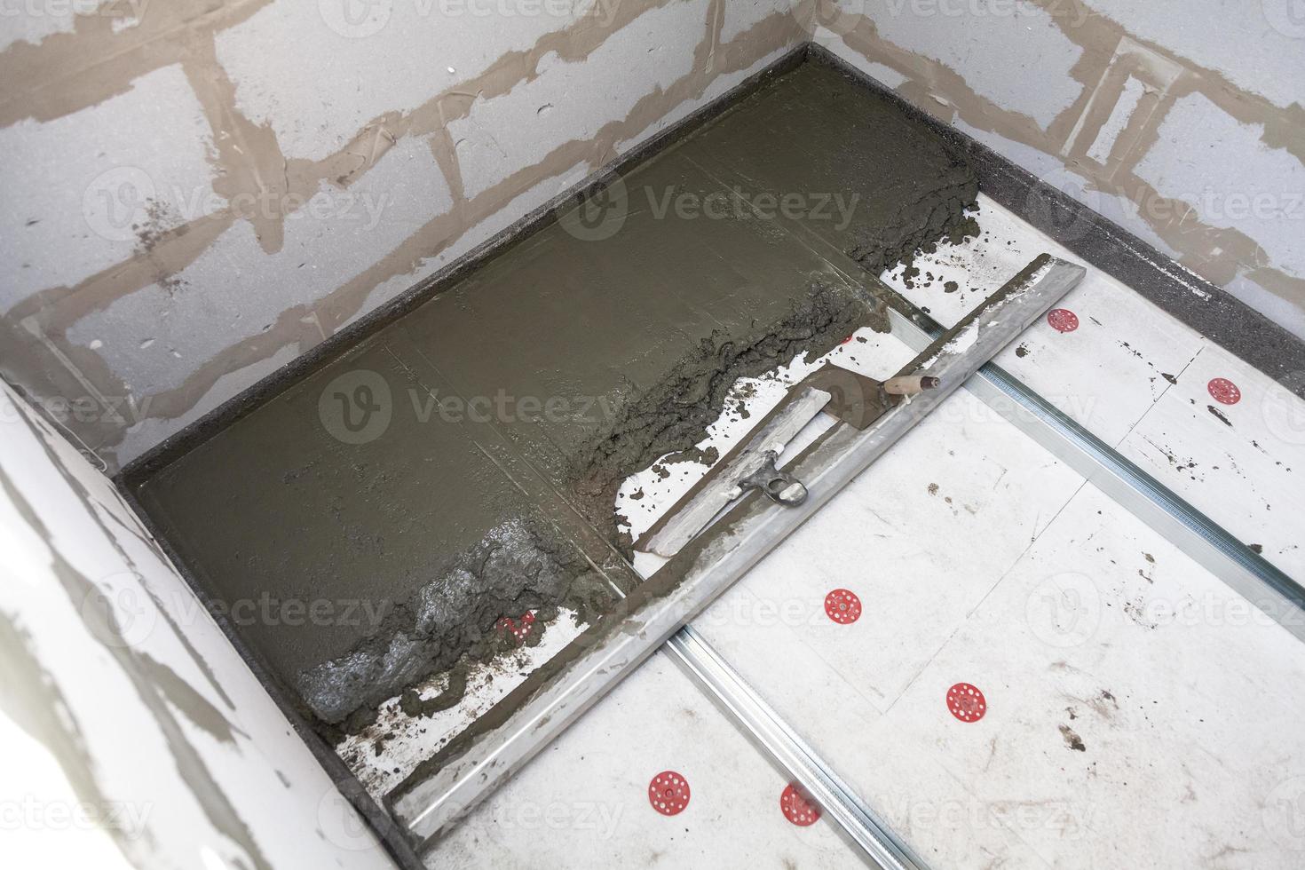 plastering concrete on the floor at the house construction photo