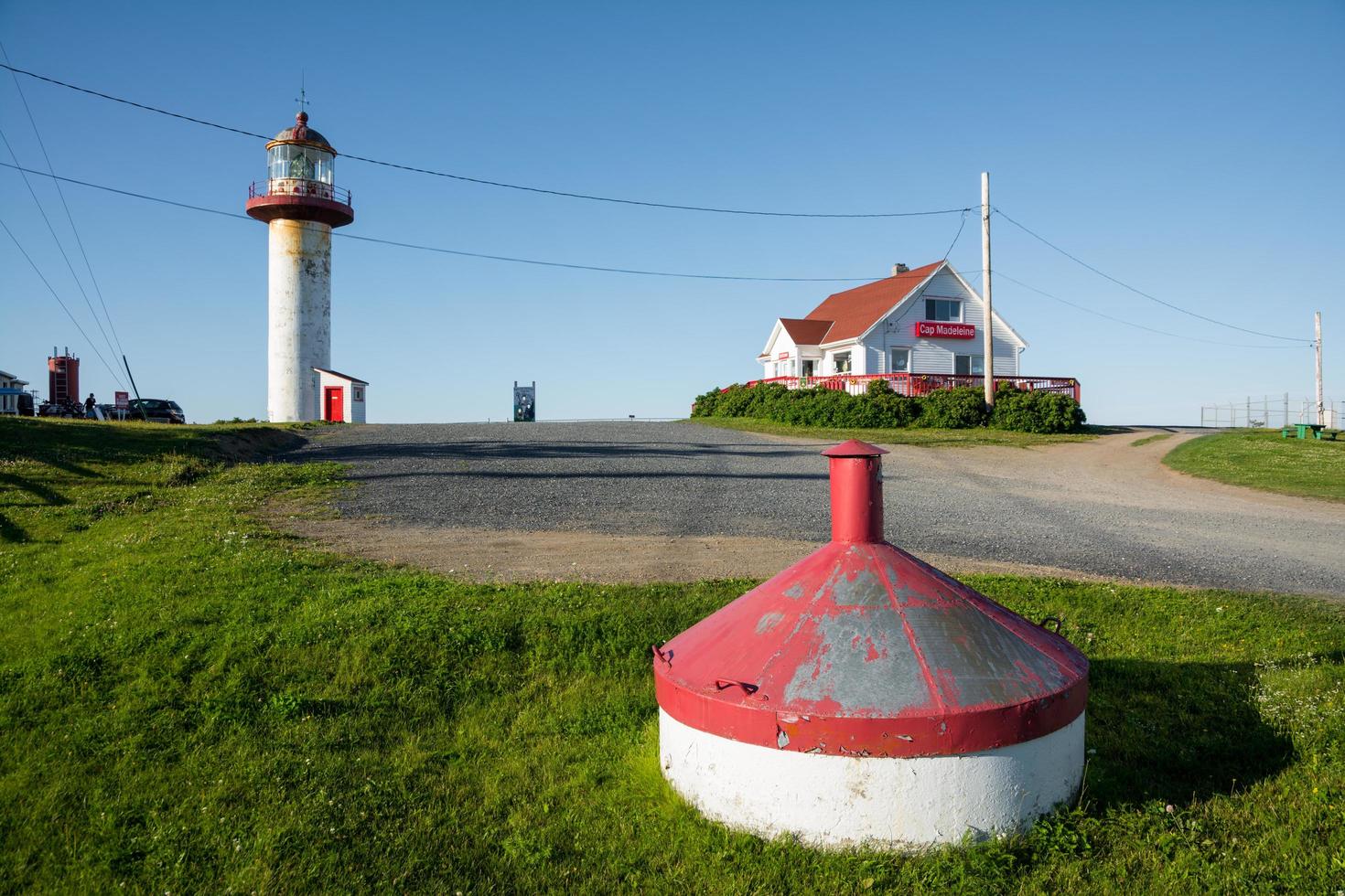 La Matre, Canada-August 9, 2015-View of the Phare de Cap Madeleine, one of Gaspesie's many iconic lighthouses during a sunny day photo