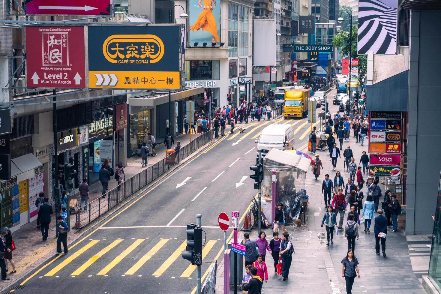 Hong Kong,March 25,2019-Traffic and people among the skyscrapers through the streets of Hong Kong during a cloudy day photo