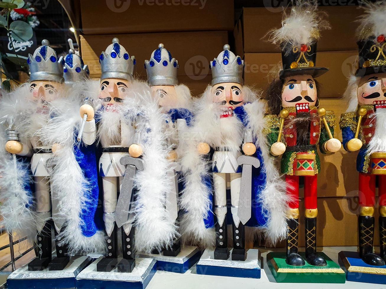 Several different nutcraker soldiers toys displayed in a store, christmas decoration for sale in market Happy New Year photo