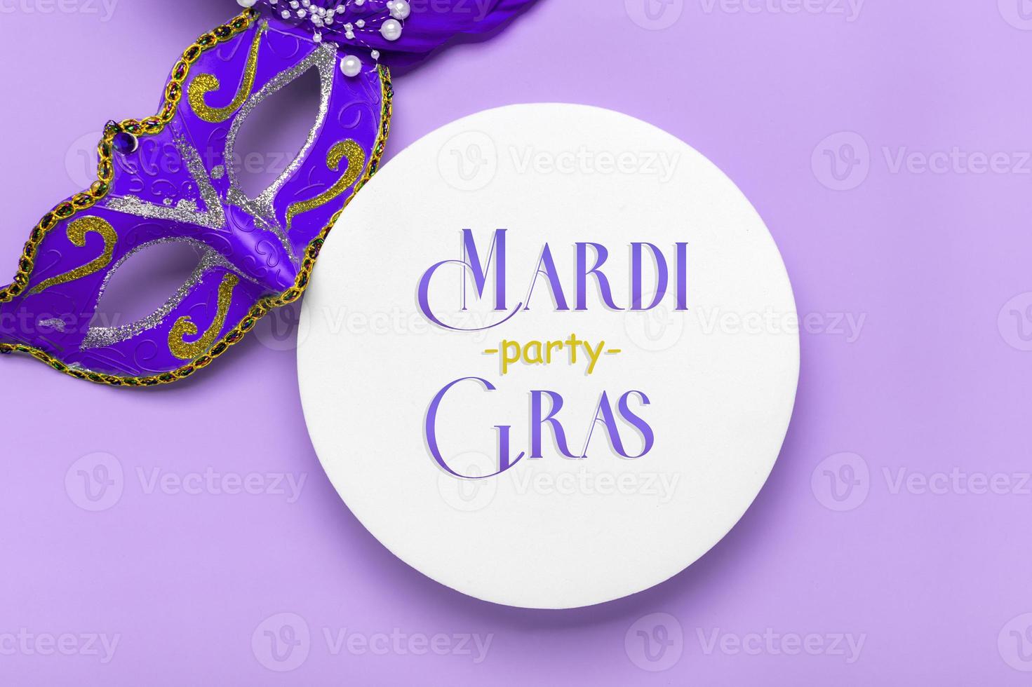 Mardi gras lettering. Congratulation card with mask on white podium on violet background Top view 2022 Mardi Gras Parade Schedule photo