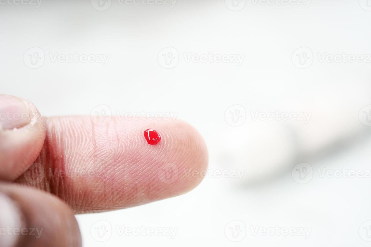 man's hand measuring blood sugar level photo