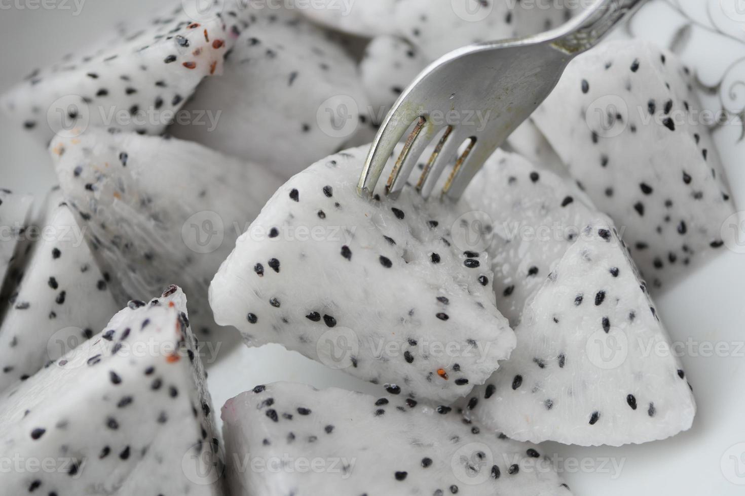 slice of dragon fruit on a chopping board. photo