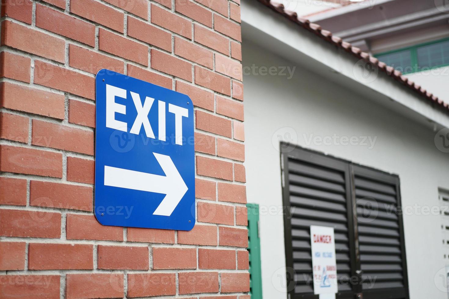 exit sign on brick wall photo