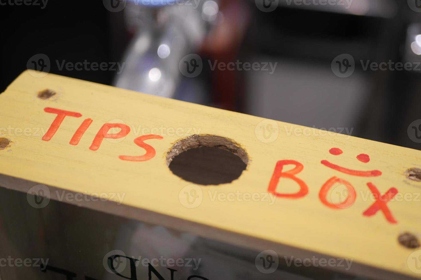 close up of a tips box in a cafe photo