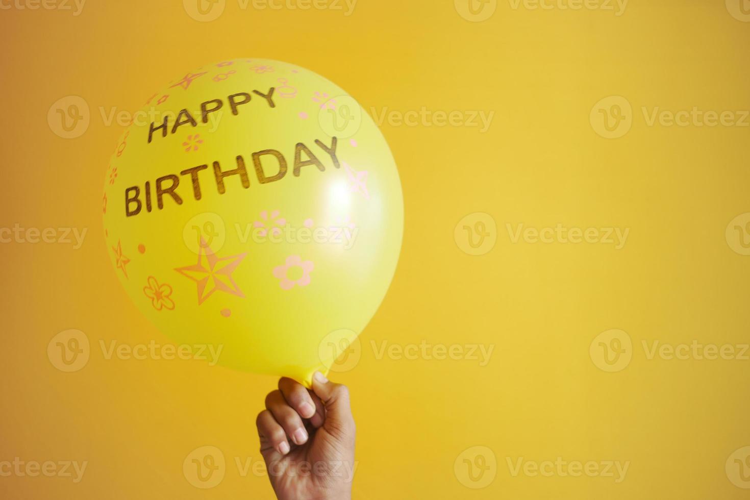 happy birthday test on yellow color Balloons photo