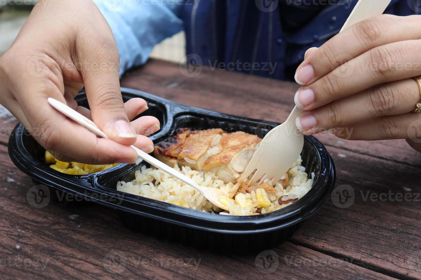 curry chicken and rice in a take away plastic packet on table photo