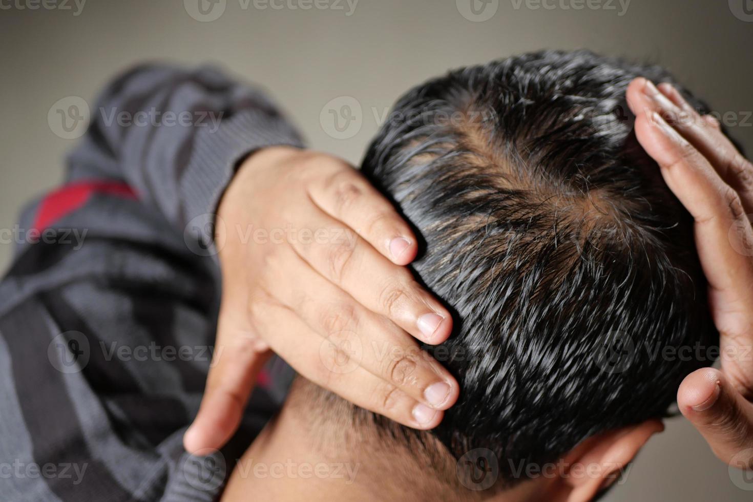 hair loss concept with man checking his hair photo