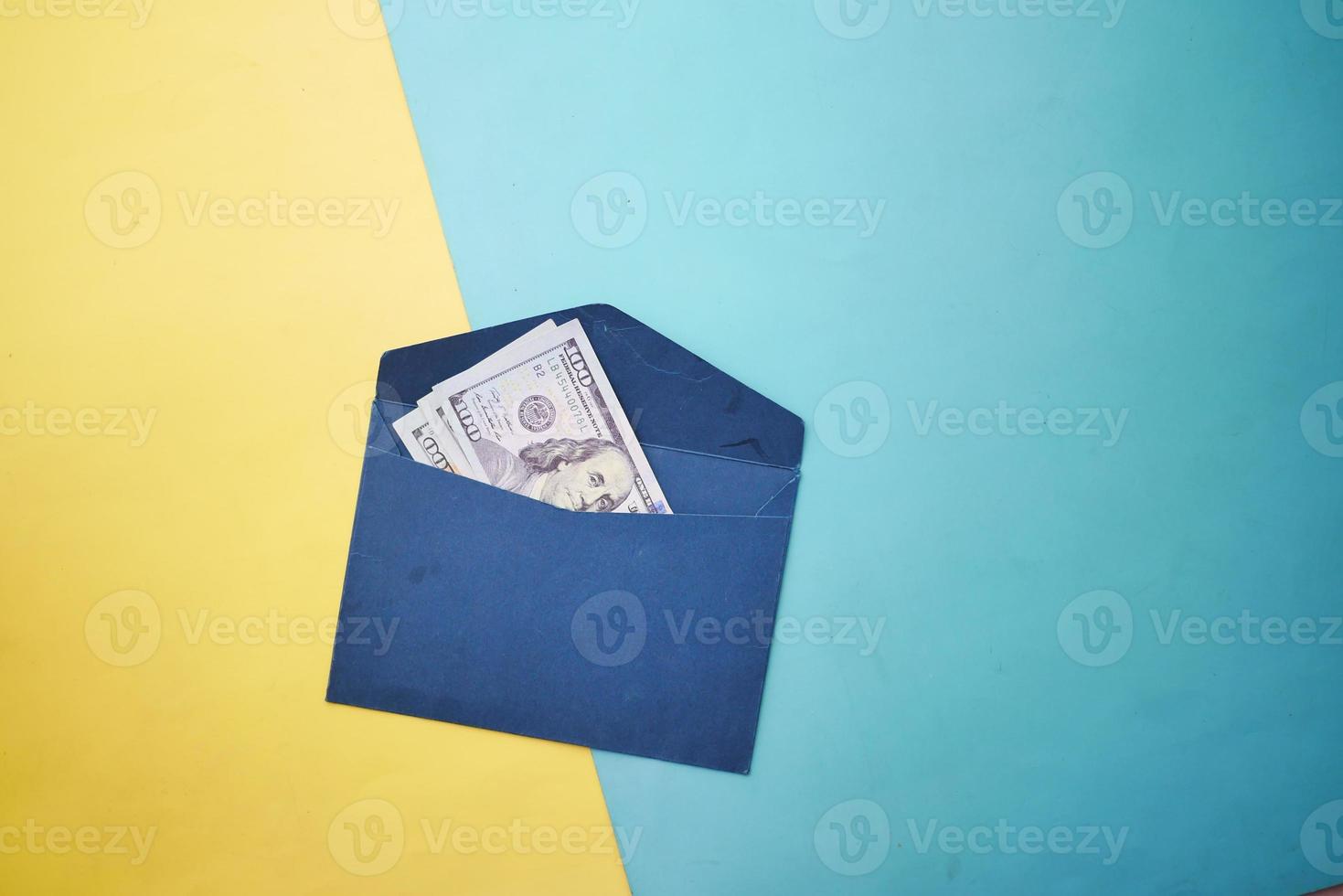 100 dollar cash in a envelope on a desk photo