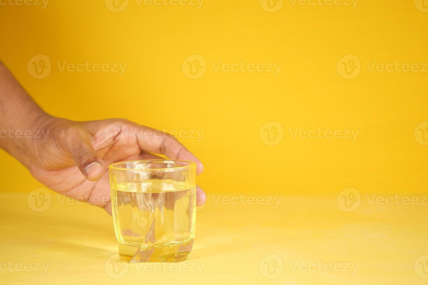 hand pick a glass of water on table photo