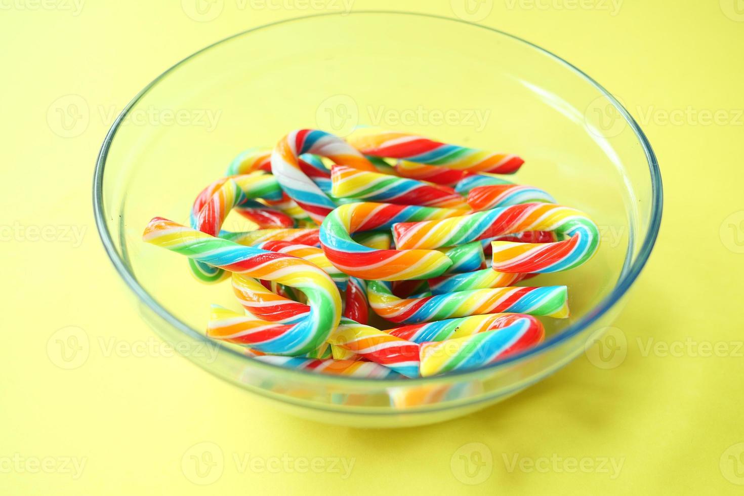 mini cherry candy canes on white background photo