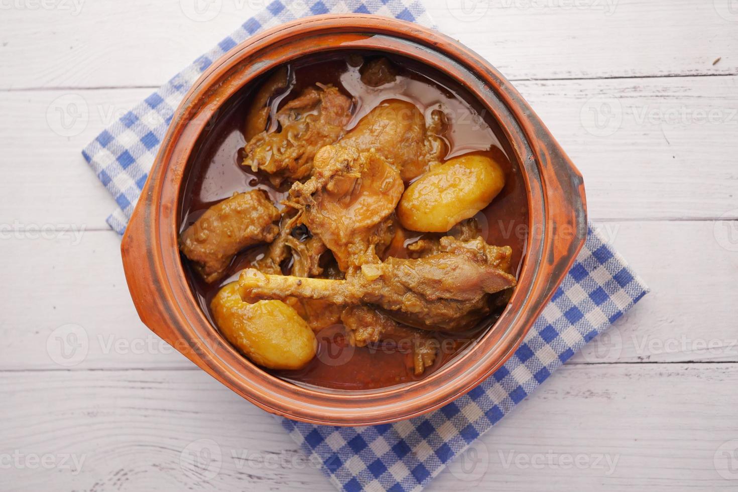 Chicken curry or masala in a bowl on table photo