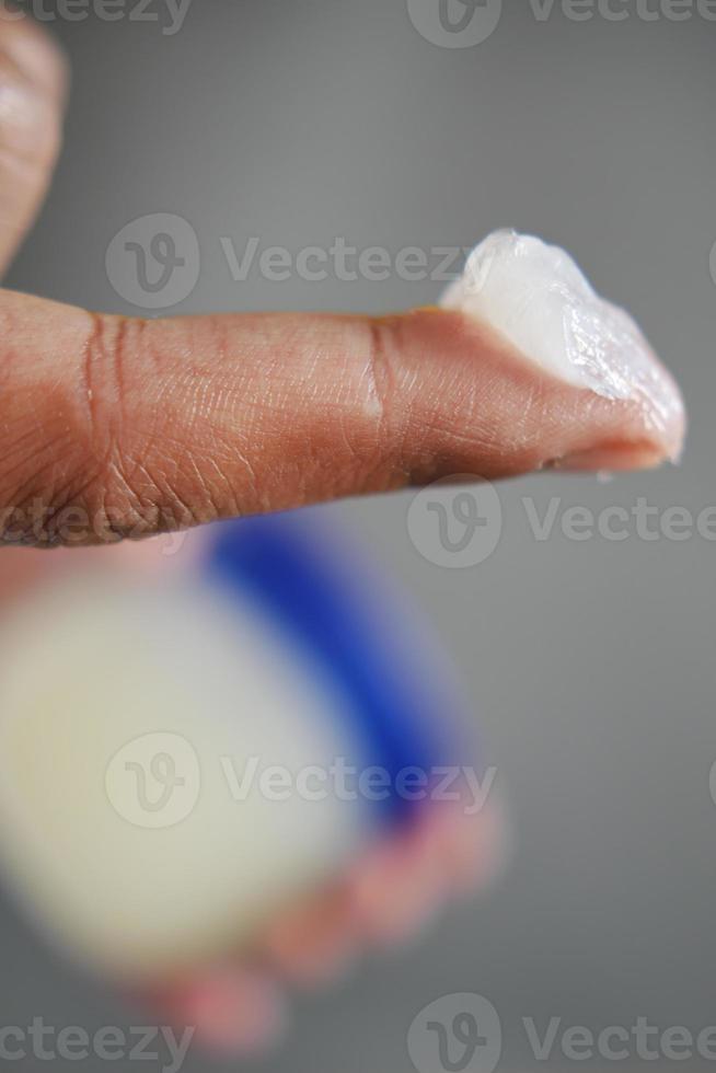 Close up of man hand using petroleum jelly photo