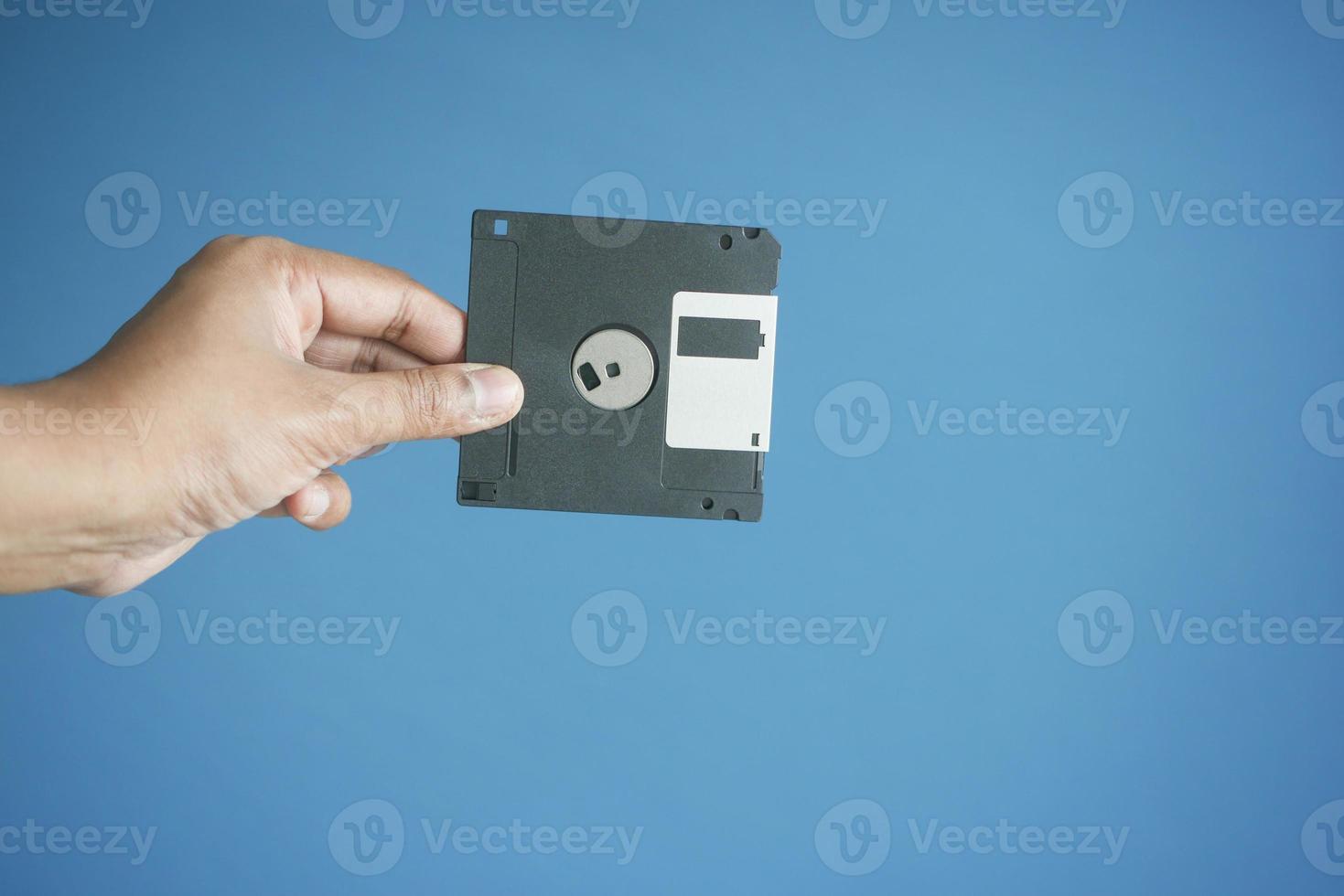 holding a an old vintage floppy disk photo