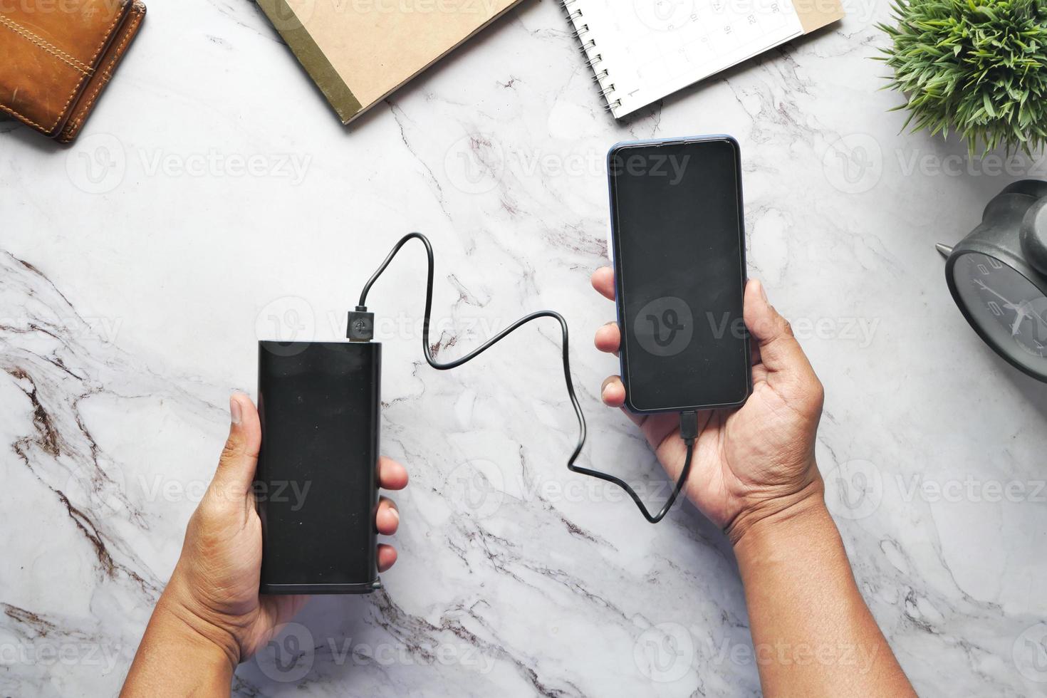 smart phone with empty screen charging with Power bank top view photo