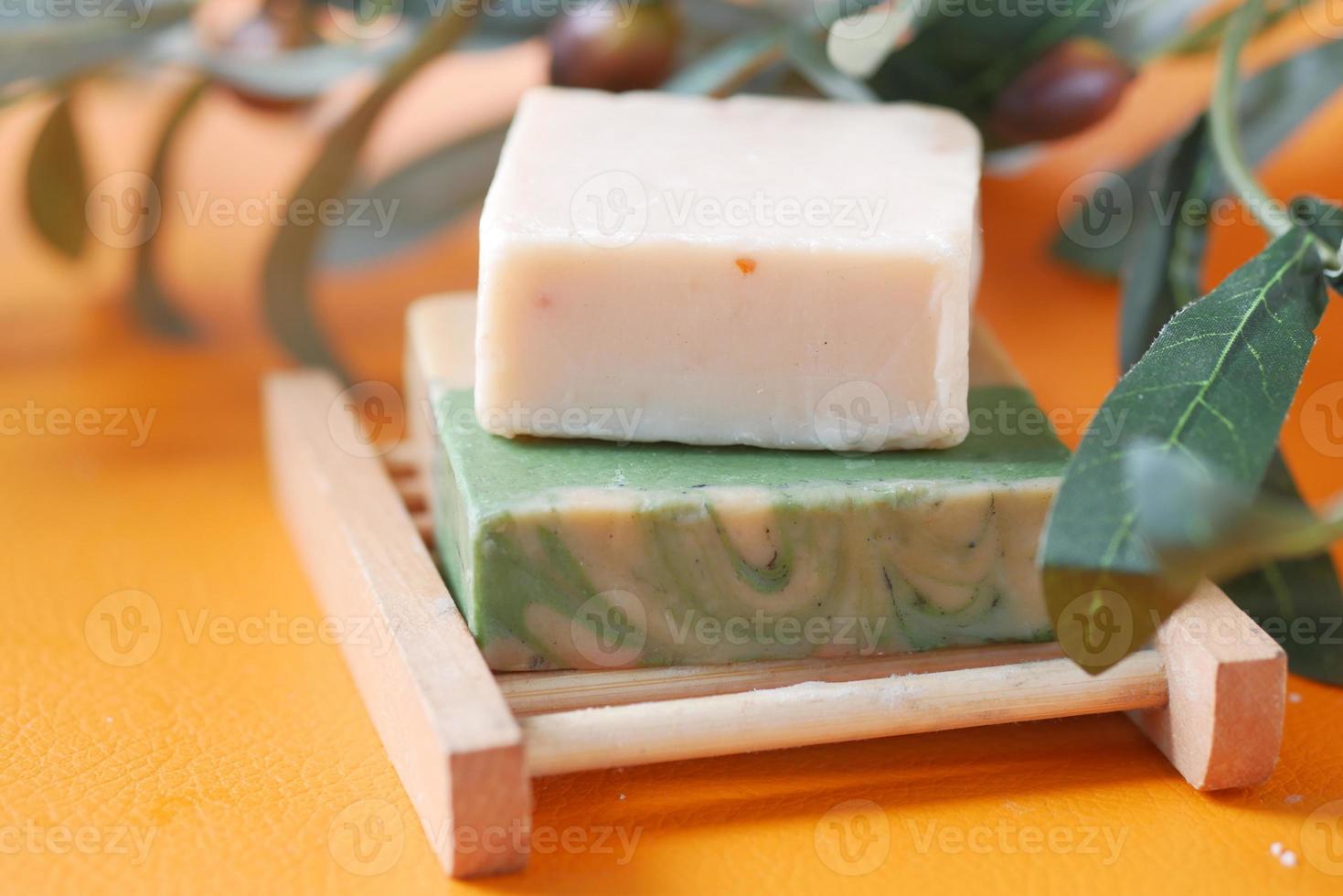 Homemade natural soap bar and dry flower on black background photo
