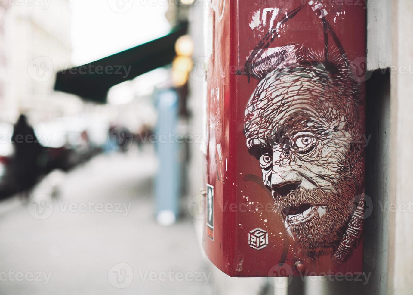 drawing, graffiti portrait painted on a box on a city street. photo