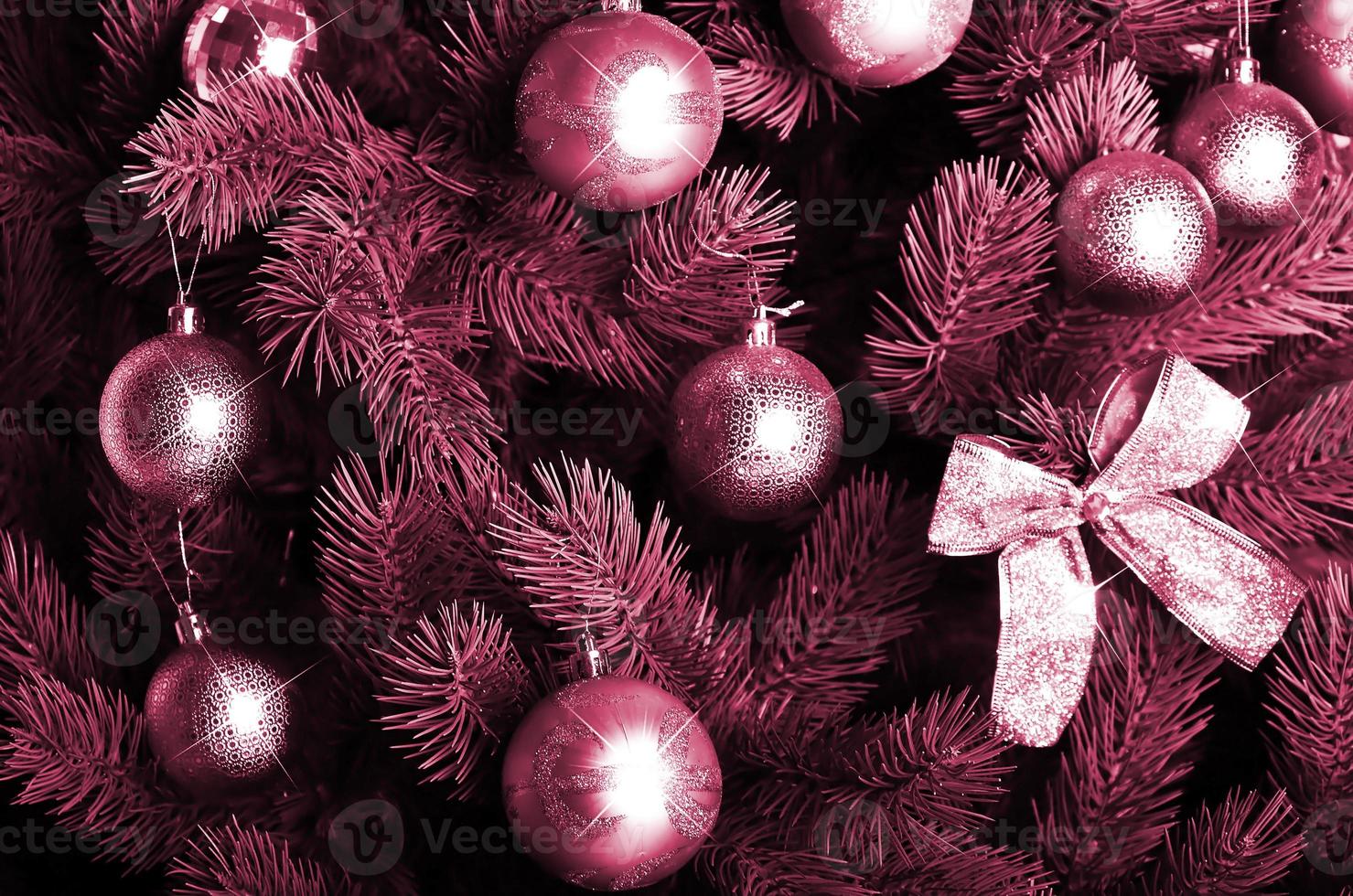 Detailed photo of the Christmas tree. Image toned in Viva Magenta, color of the 2023 year