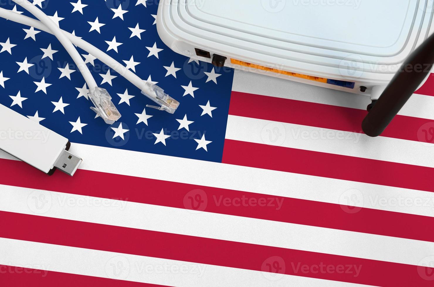 United States of America flag depicted on table with internet rj45 cable, wireless usb wifi adapter and router. Internet connection concept photo
