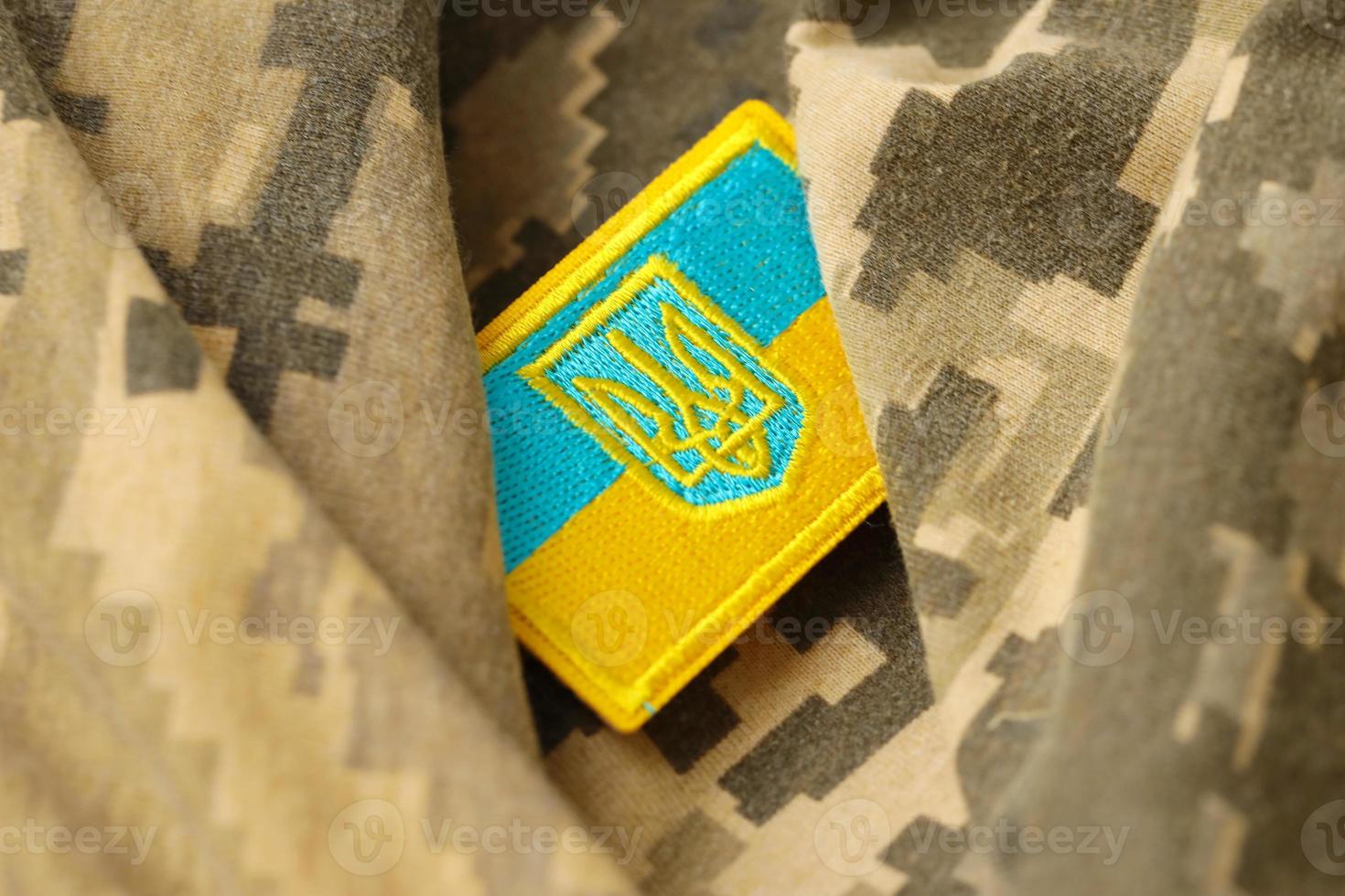 Military camouflage fabric with ukrainian flag on uniform chevron photo