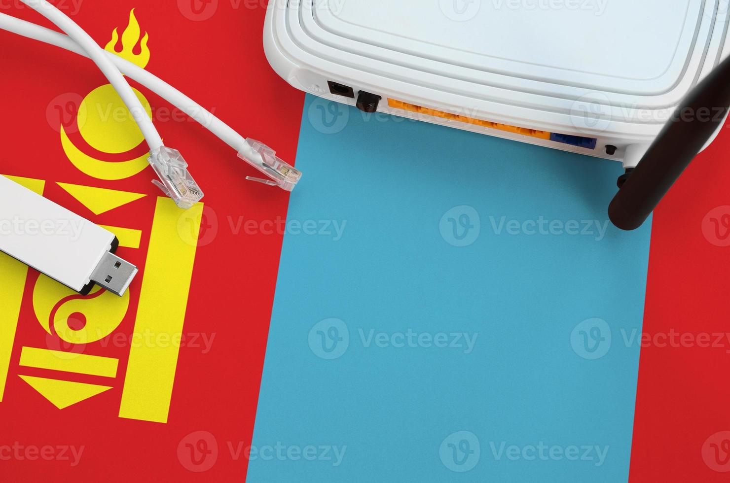 Mongolia flag depicted on table with internet rj45 cable, wireless usb wifi adapter and router. Internet connection concept photo