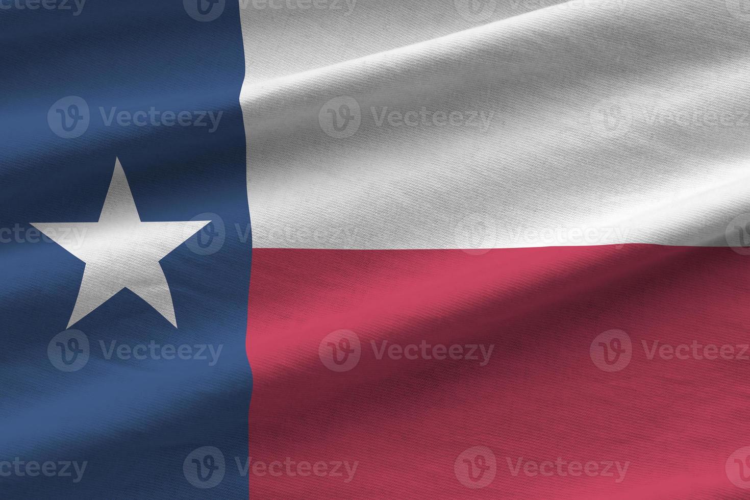 Texas US state flag with big folds waving close up under the studio light indoors. The official symbols and colors in banner photo