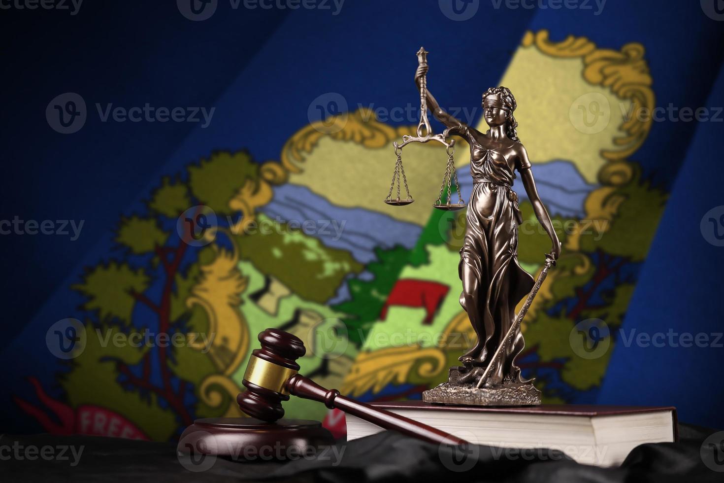 Vermont US state flag with statue of lady justice, constitution and judge hammer on black drapery. Concept of judgement and guilt photo