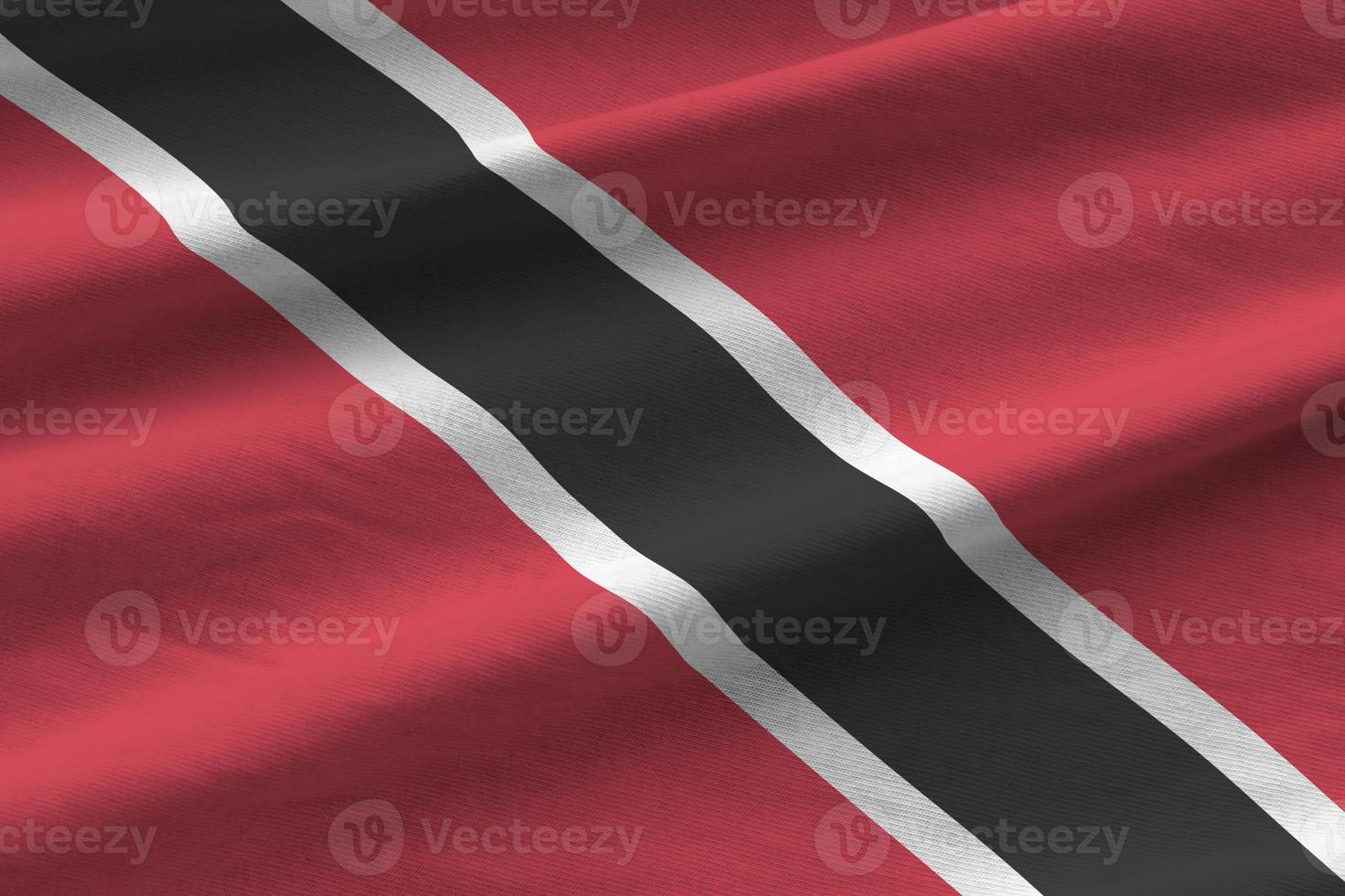 Trinidad and Tobago flag with big folds waving close up under the studio light indoors. The official symbols and colors in banner photo