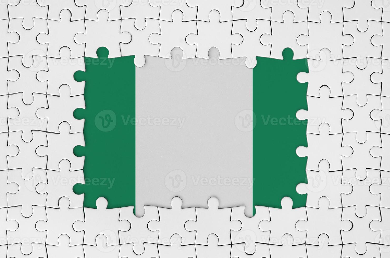 Nigeria flag in frame of white puzzle pieces with missing central part photo